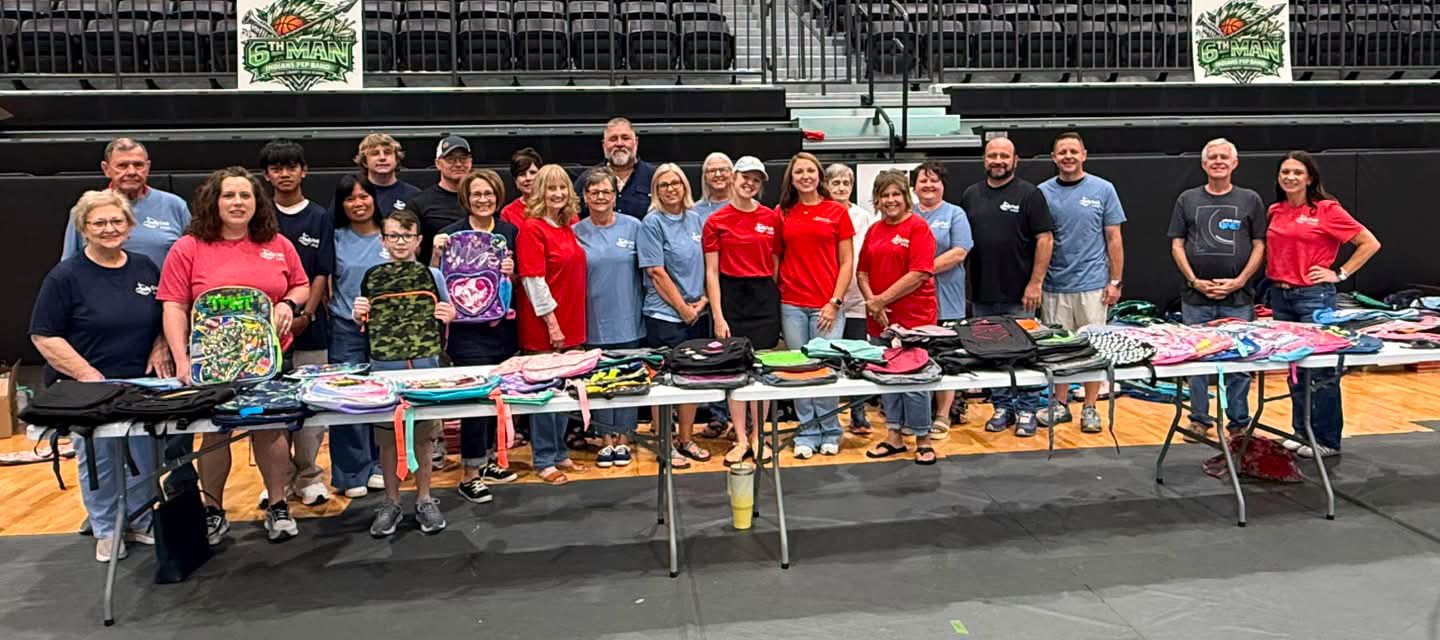Holly Creek volunteers serving children with backpacks